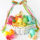 Colorful Easter Basket with Decorated Eggs and Bow on White Background