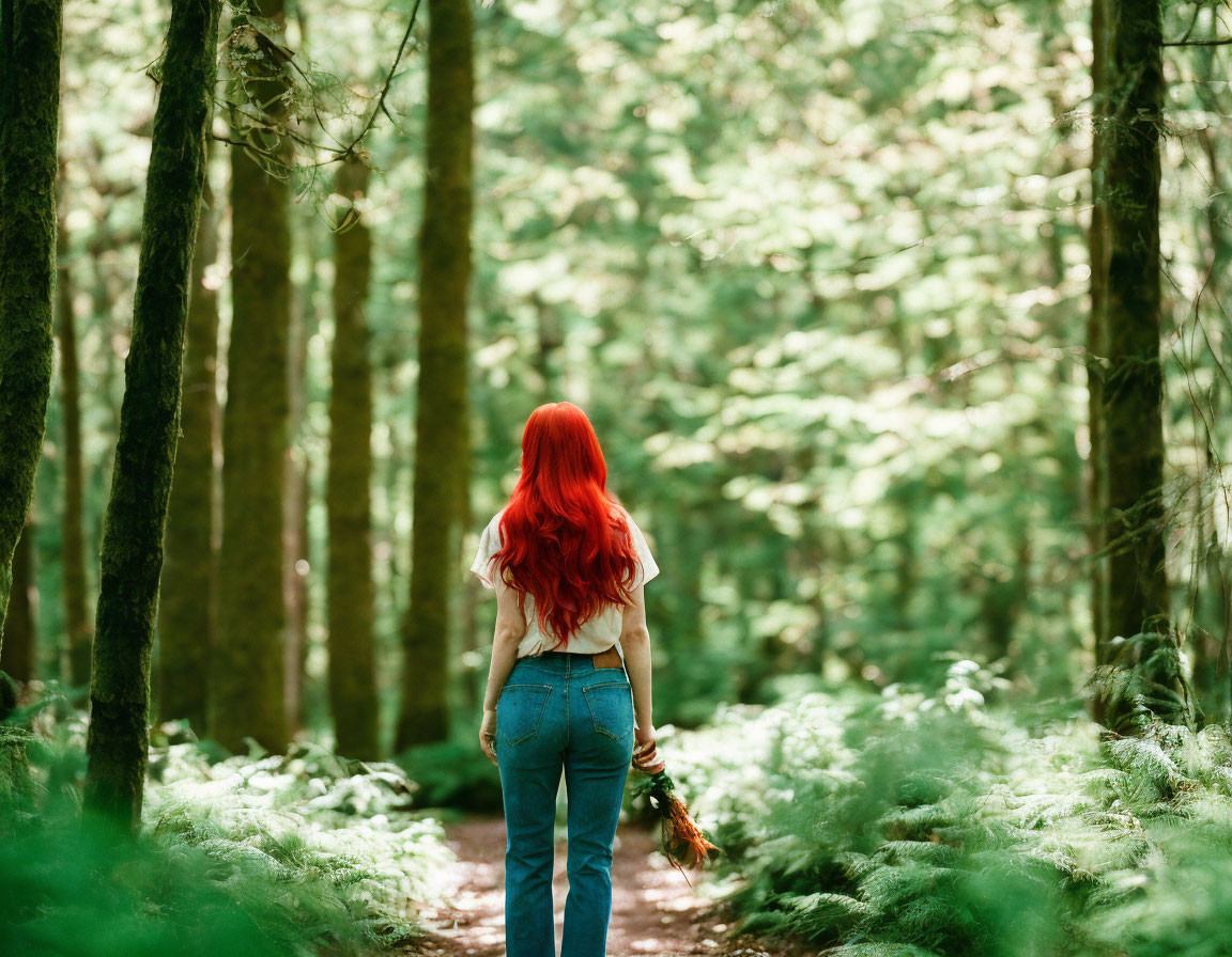 Vibrant red-haired woman in lush forest setting