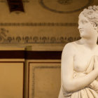 Marble sculpture of woman's bust with sphere, intricate hair details