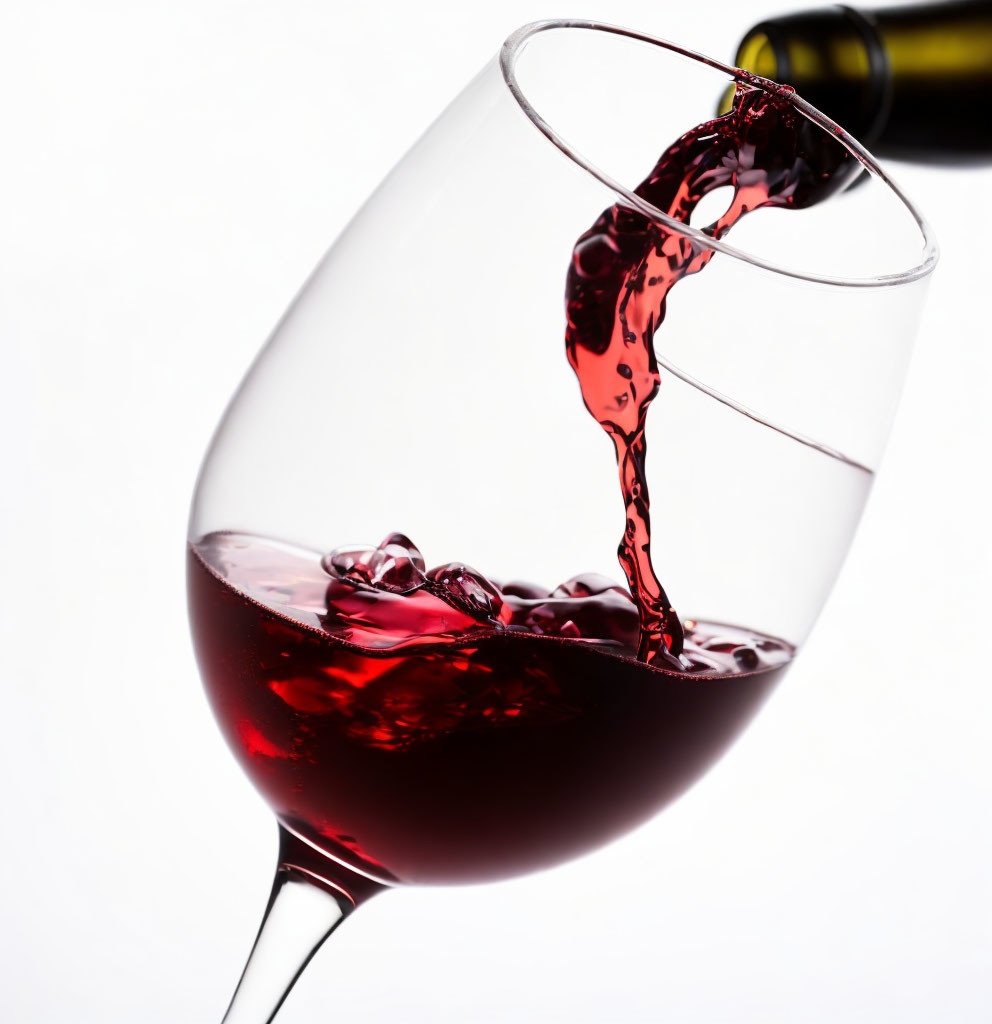 Pouring Red Wine into Tilted Glass on White Background