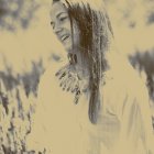 Woman in sunlit field of tall grasses, contemplative and serene