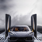 Luxurious sports car with upward-opening doors on asphalt road