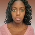 Portrait of Woman with Striking Green Eyeshadow and Purple Outfit