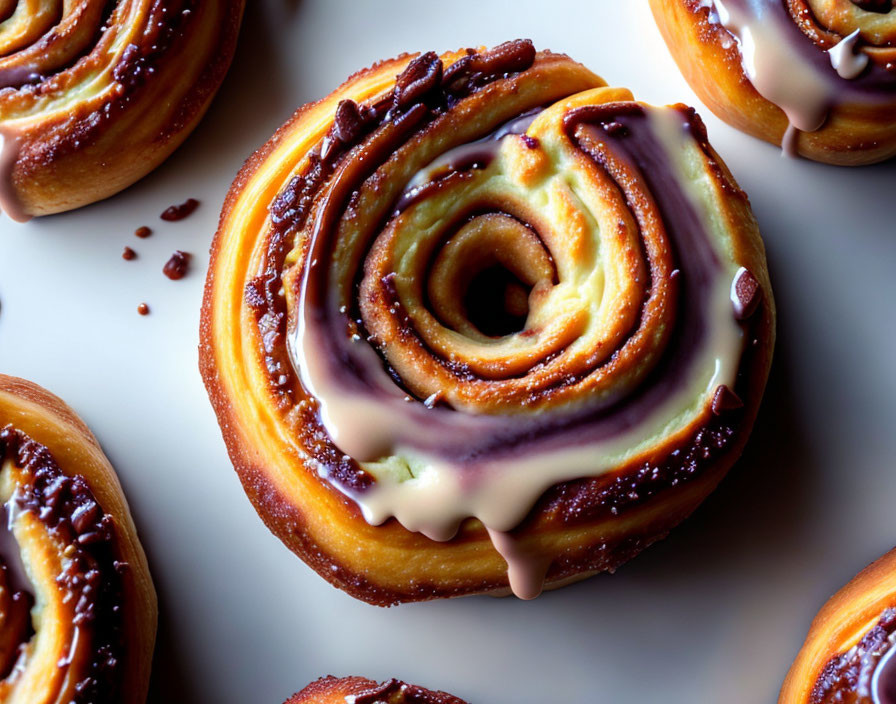 Cinnamon rolls with creamy icing and crushed nuts on a plate