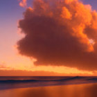 Vibrant ocean sunset with orange and purple hues and large fiery clouds