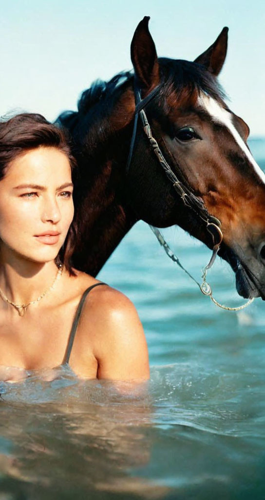 Woman and horse in water with serene expression, ocean background