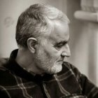 Grayscale photo: Bearded man with salt-and-pepper hair in profile.