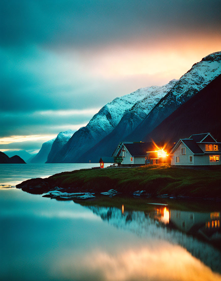 Serene lake at twilight with snow-capped mountains reflected