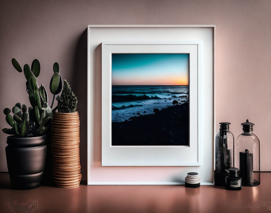 Ocean sunset photo with cactus and glass bottles on shelf