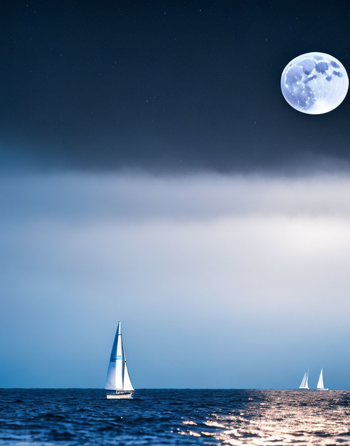 Night sky with full moon illuminating sailboats on serene ocean