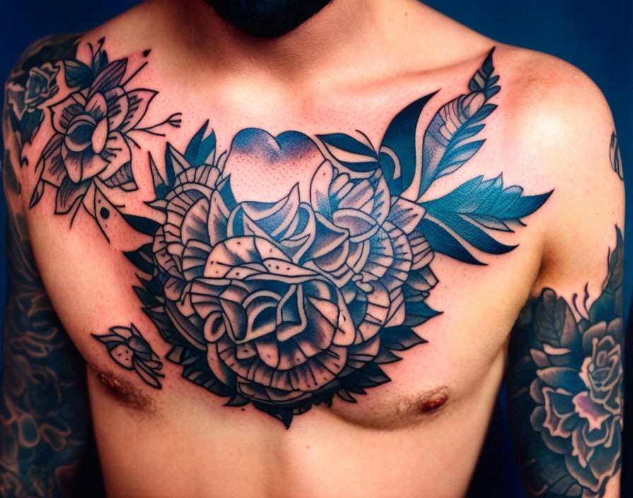 Intricate floral chest tattoo design with heart motif