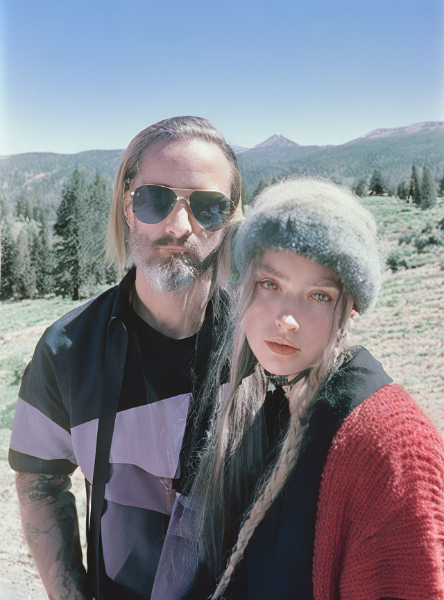 Bearded man and woman with braided hair in nature scenery