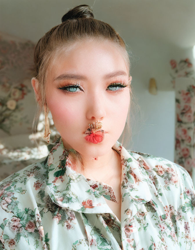 Individual with High Bun Hairstyle in Floral Print Attire and Bee-Themed Makeup