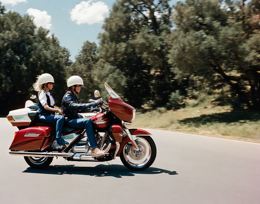 Two Individuals on Red Touring Motorcycle on Sunny Day