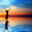 Blue dress figure with clear sphere on reflective beach at sunset