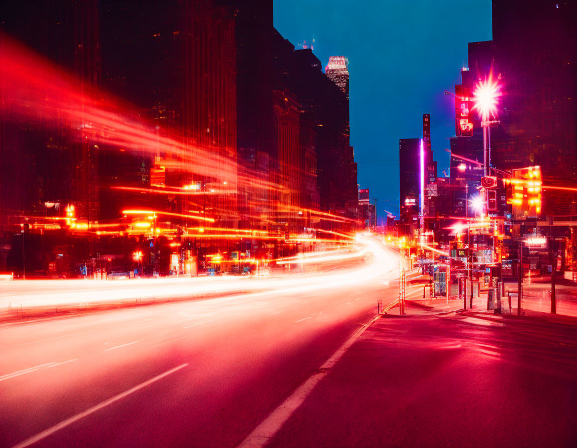 Bustling city street at night with red and white light streaks