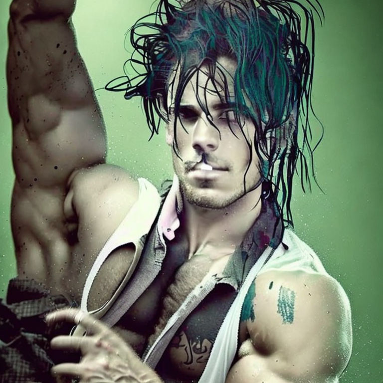 Muscular man with blue-tinted hair and tattoos in sleeveless top against green backdrop