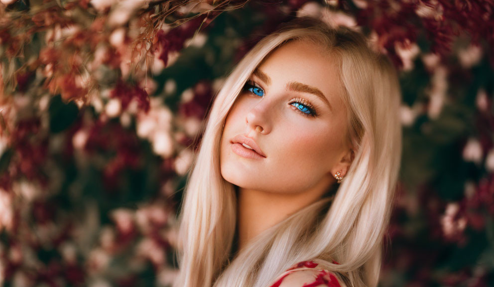 Woman with Blue Eyes and Blonde Hair Surrounded by Pink Leaves