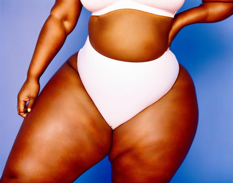 Woman in Pink Crop Top and White Bottoms on Blue Background