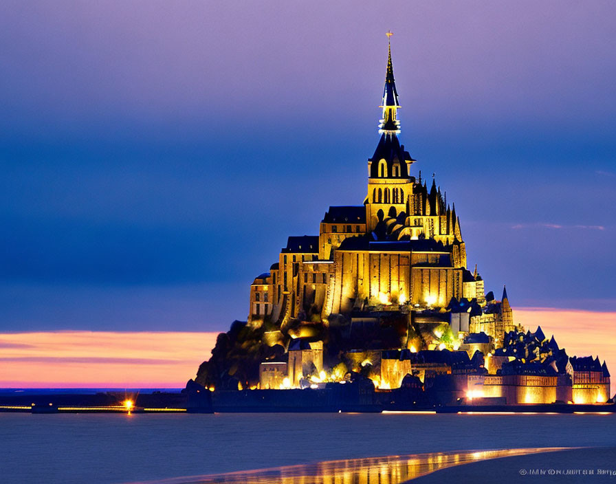 Medieval castle structure overlooking water at twilight