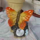 Colorful Paper Butterfly on White Flowers with Warm Background