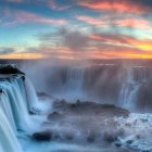 Fantastical winter scene with ships near cliff edge and waterfall at dawn or dusk