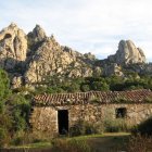 Rustic village watercolor: stone houses, castle, greenery