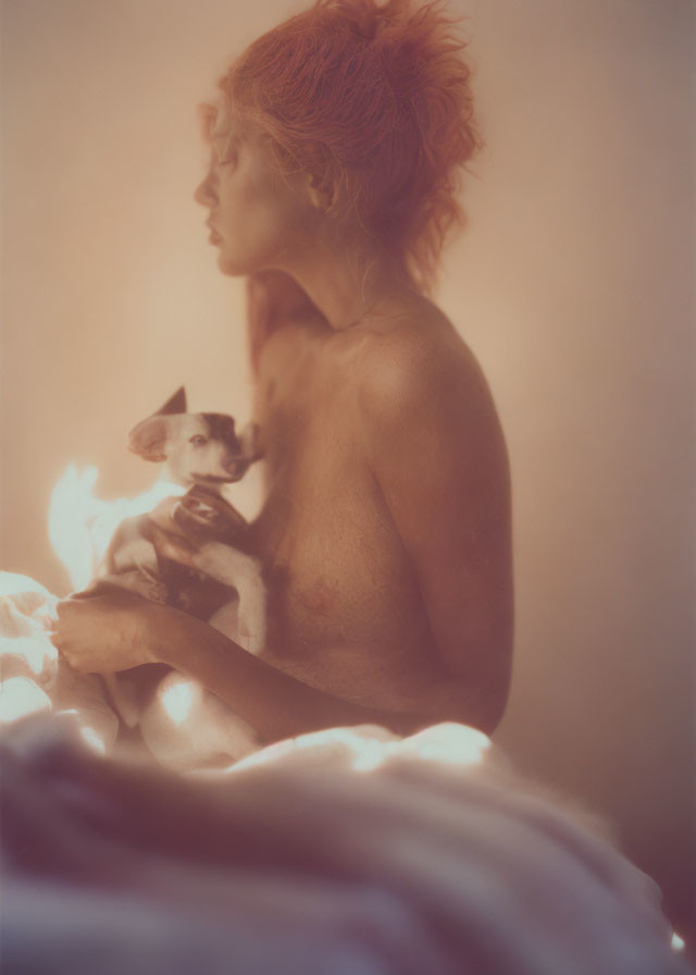 Red-Haired Person Holding Small Dog in Warm Light