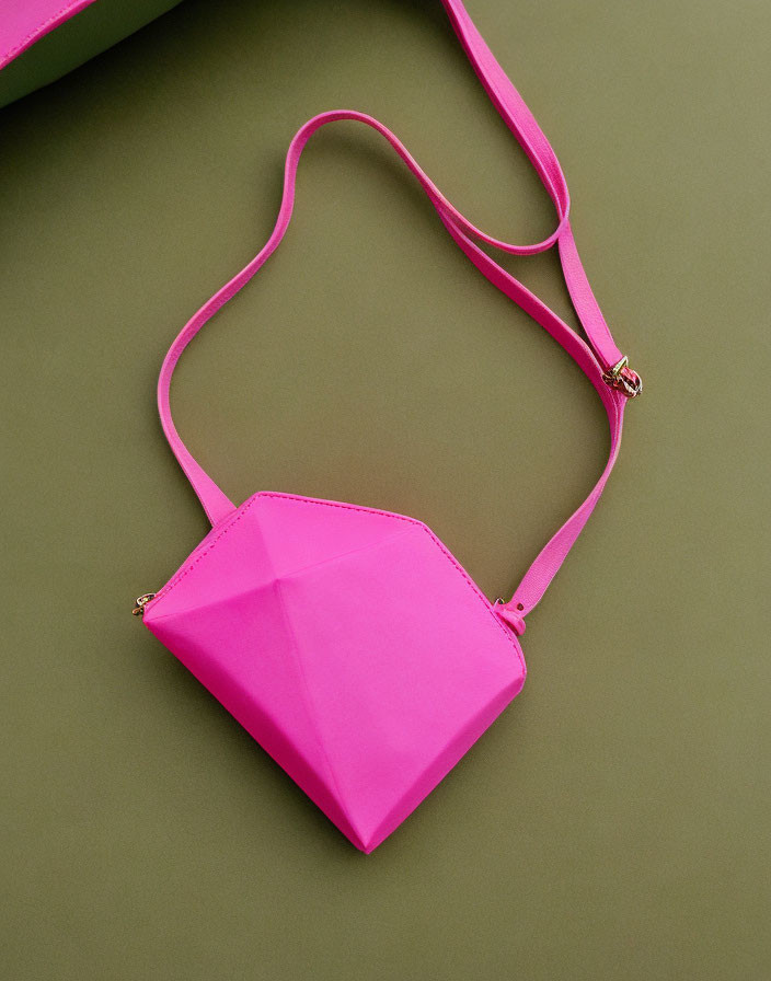 Pink Hexagonal Purse with Thin Strap on Green Background