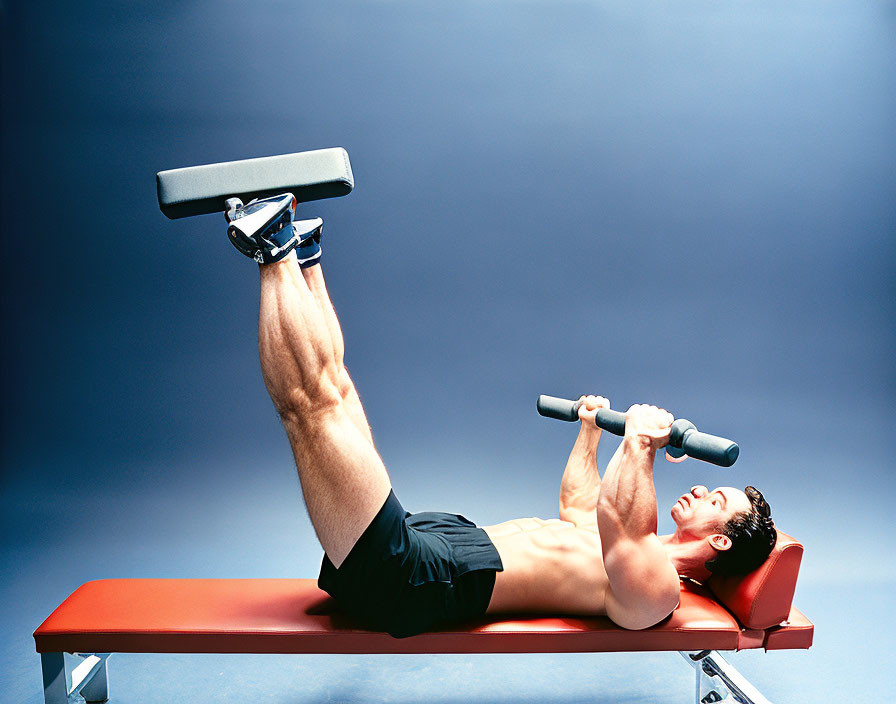 Person performing leg raises with dumbbell on red bench against blue background