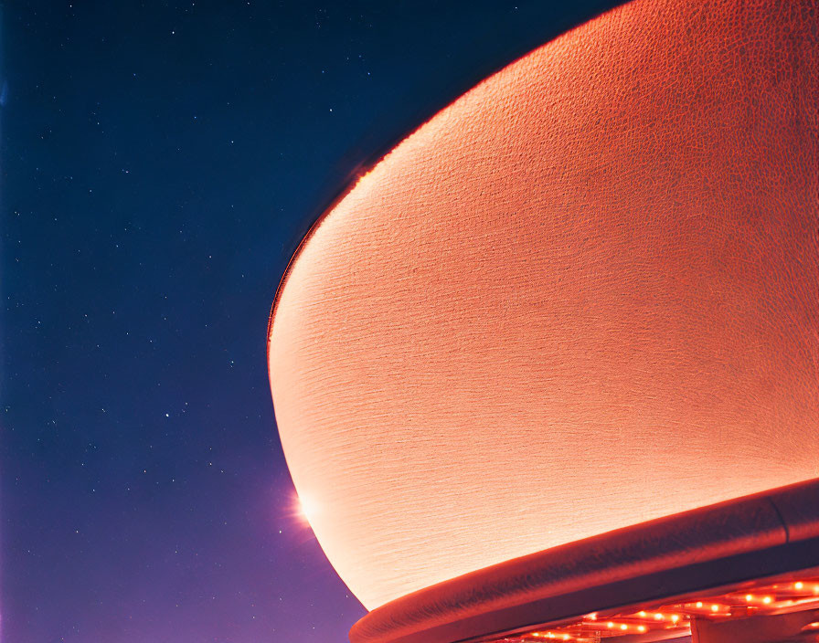 Illuminated Dome Structure Under Starry Night Sky