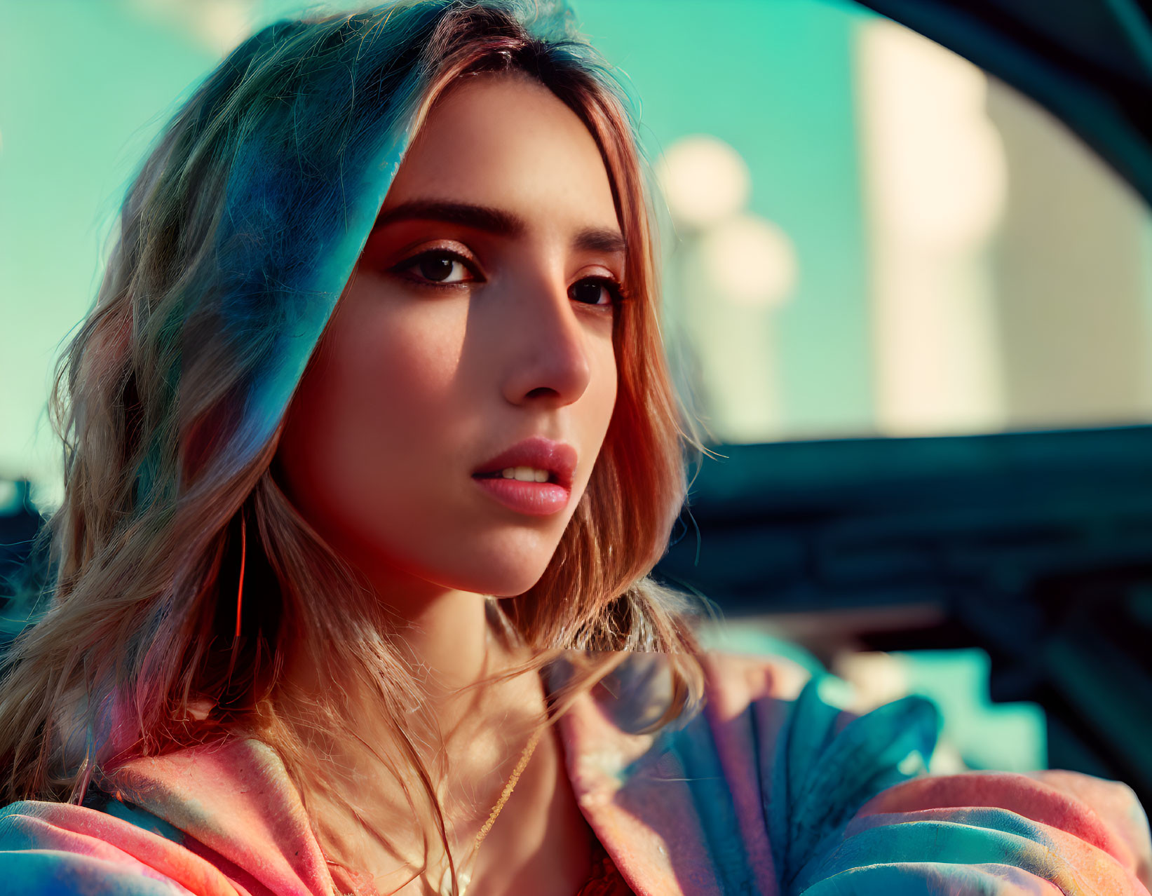 Young woman with subtle makeup gazing under warm sun glow in colorful outfit