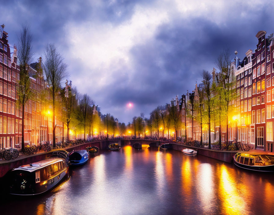 Serene Amsterdam canal at twilight with Dutch buildings and boats