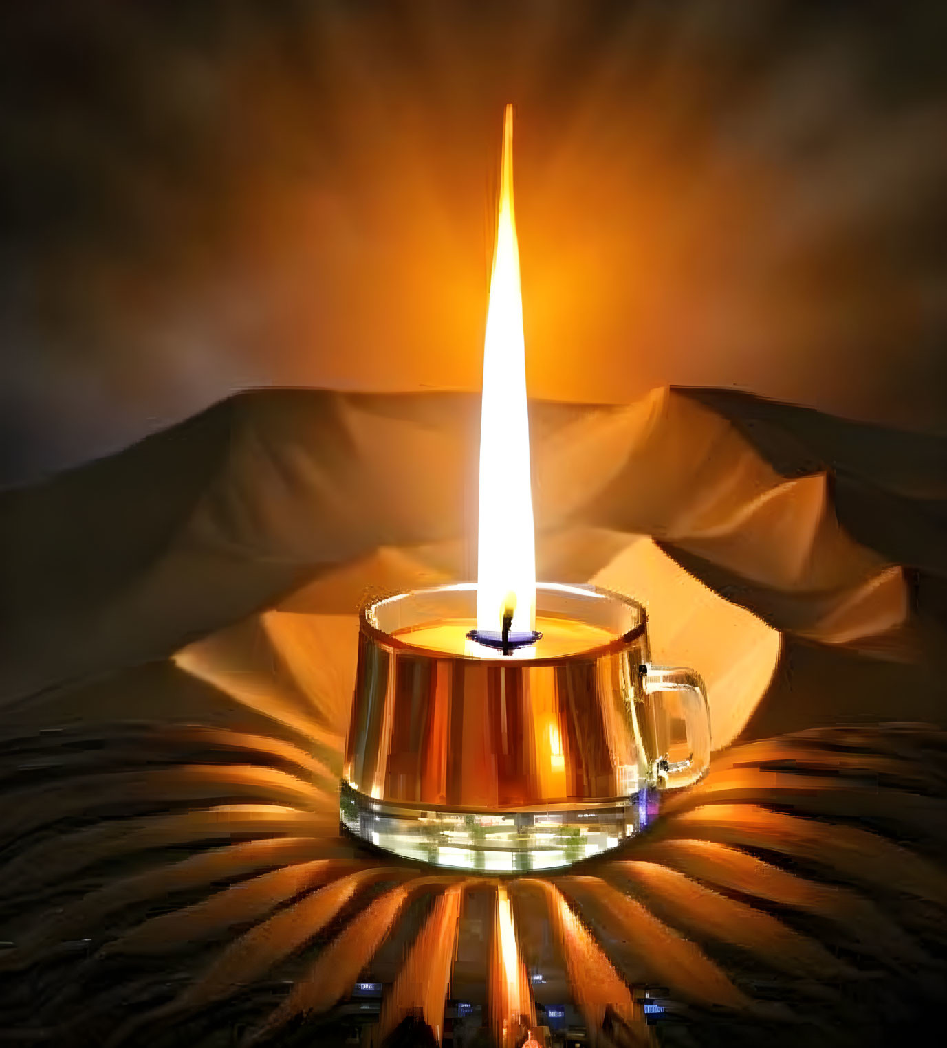 Tealight candle with bright flame on golden desert dunes backdrop