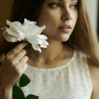 Woman with Wavy Hair Holding Pink Roses, Gazing Left