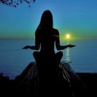 Silhouette of person meditating at sunset on hill with mountains.