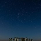 Ancient Stonehenge structure under dramatic night sky