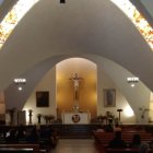 Ornate altar and flickering candles in serene church interior