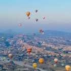 Colorful Mountains and Hot Air Balloons Over Serene Landscape