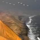 Tranquil river winding through orange sandstone formations