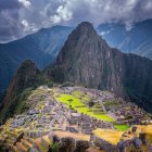 Digital artwork: Machu Picchu with neon-lit face in dramatic sky