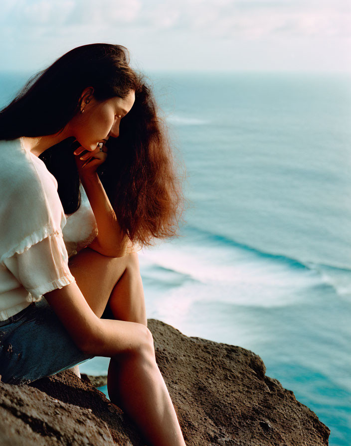 Woman Contemplating on Cliff by the Sea