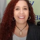 Portrait of Woman with Wavy Hair and Brown Eyes in Soft Lighting