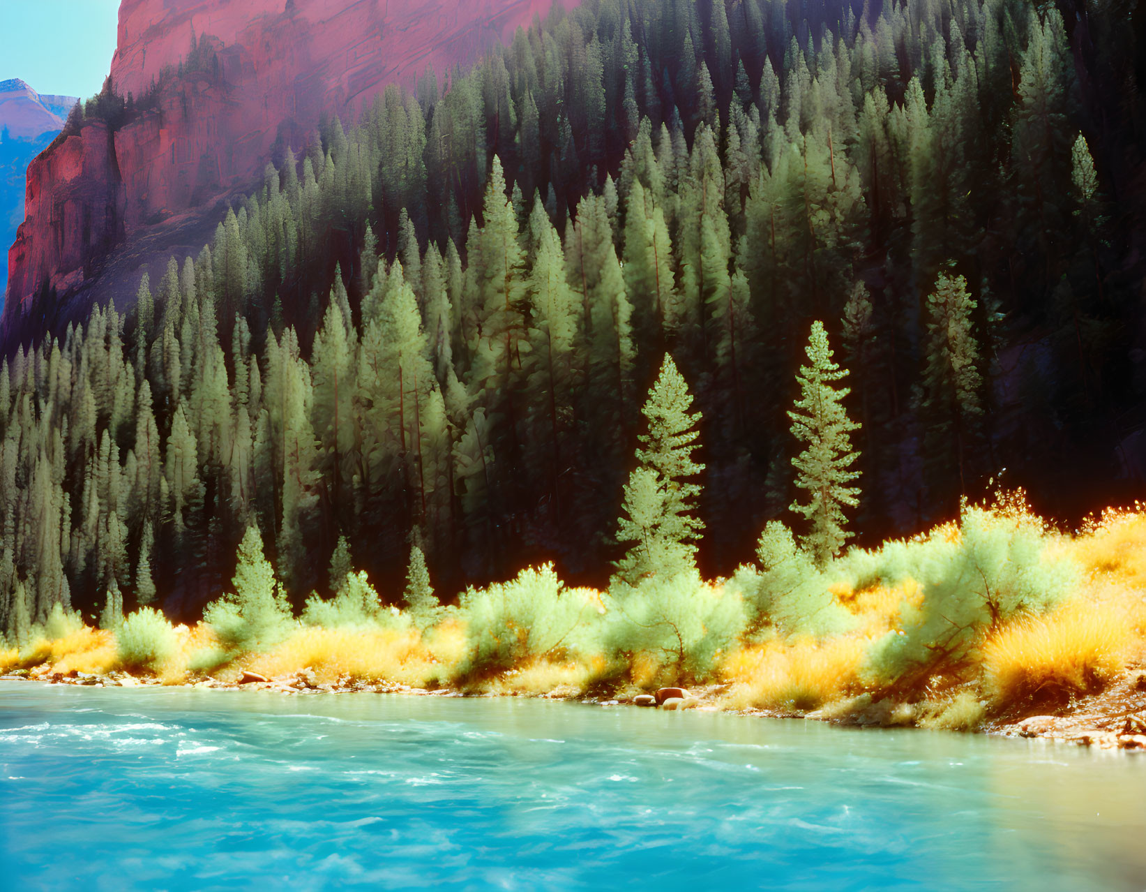 Vivid turquoise river surrounded by green trees and red cliffs