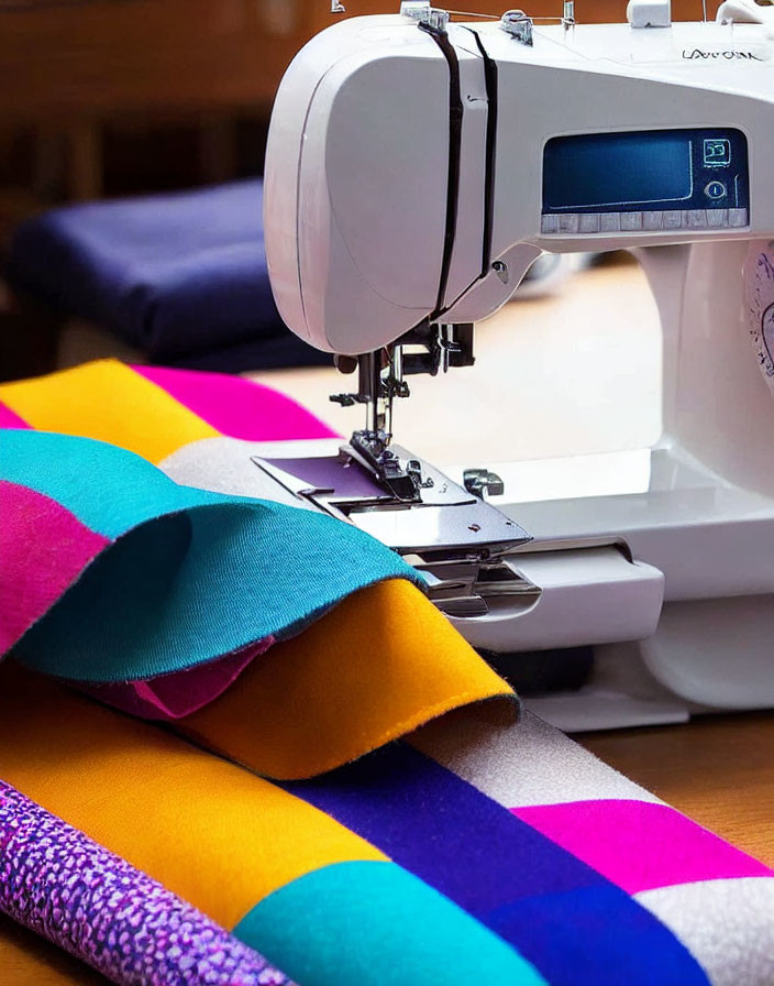 Digital Screen Sewing Machine on Table with Colorful Fabric Strips