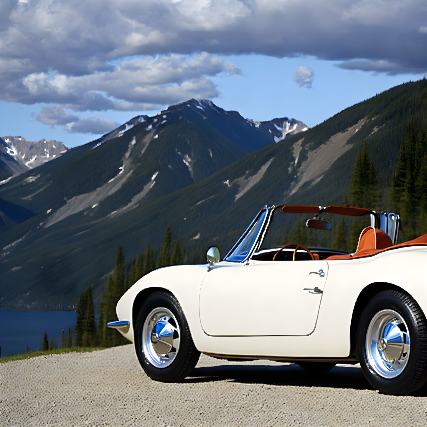 Vintage white convertible car on mountain road with lake view