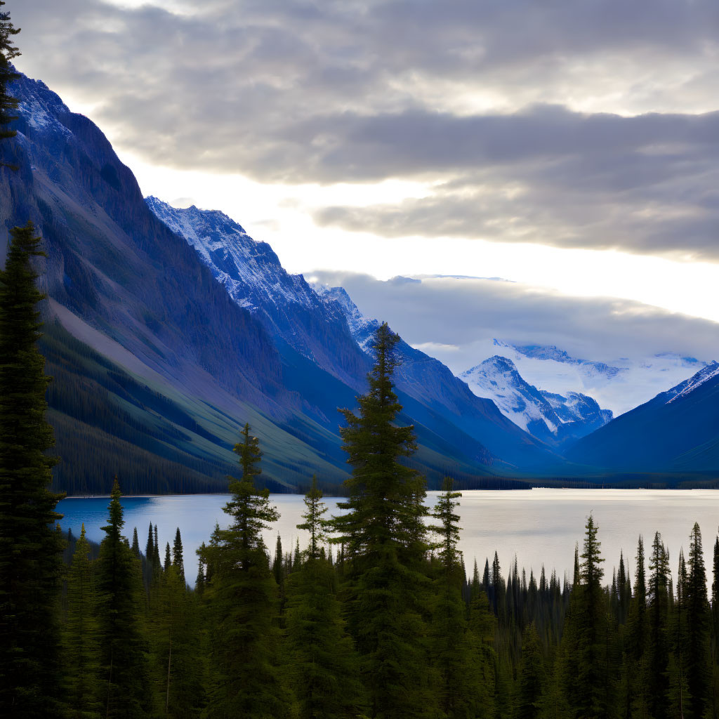 Tranquil mountain landscape at dusk with forest, lake, and cloudy sky