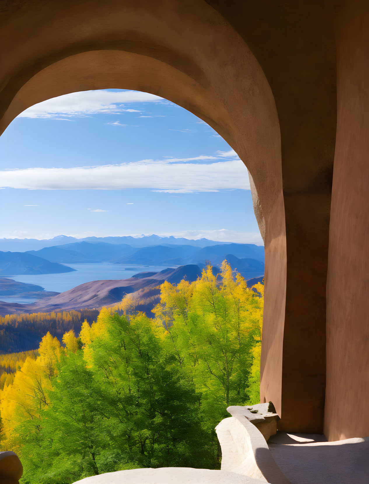 Stone arched balcony with autumn trees and blue mountains view