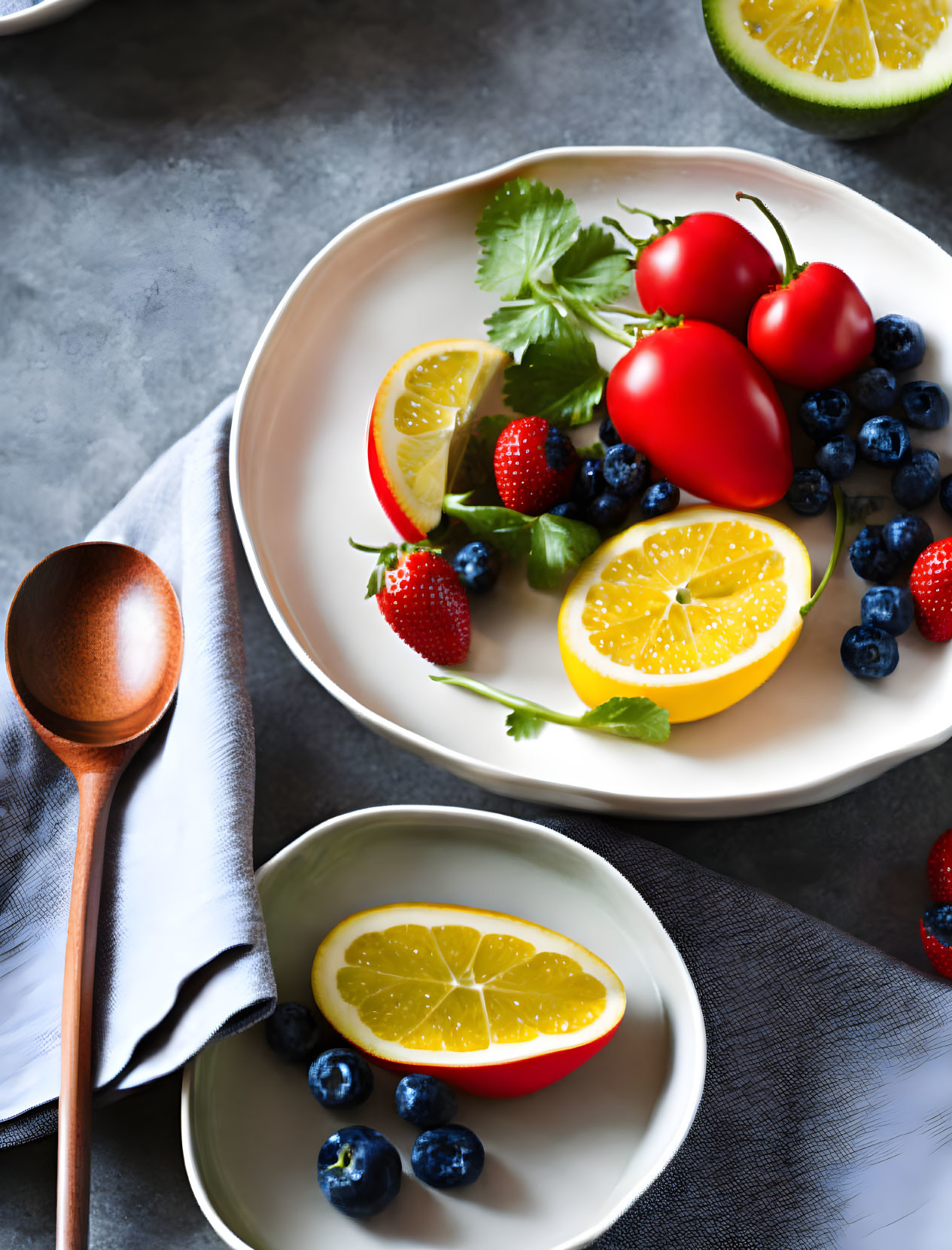 Plate with Fresh Strawberries, Blueberries, Lemon, and Cherry Tomatoes on Wooden Spoon