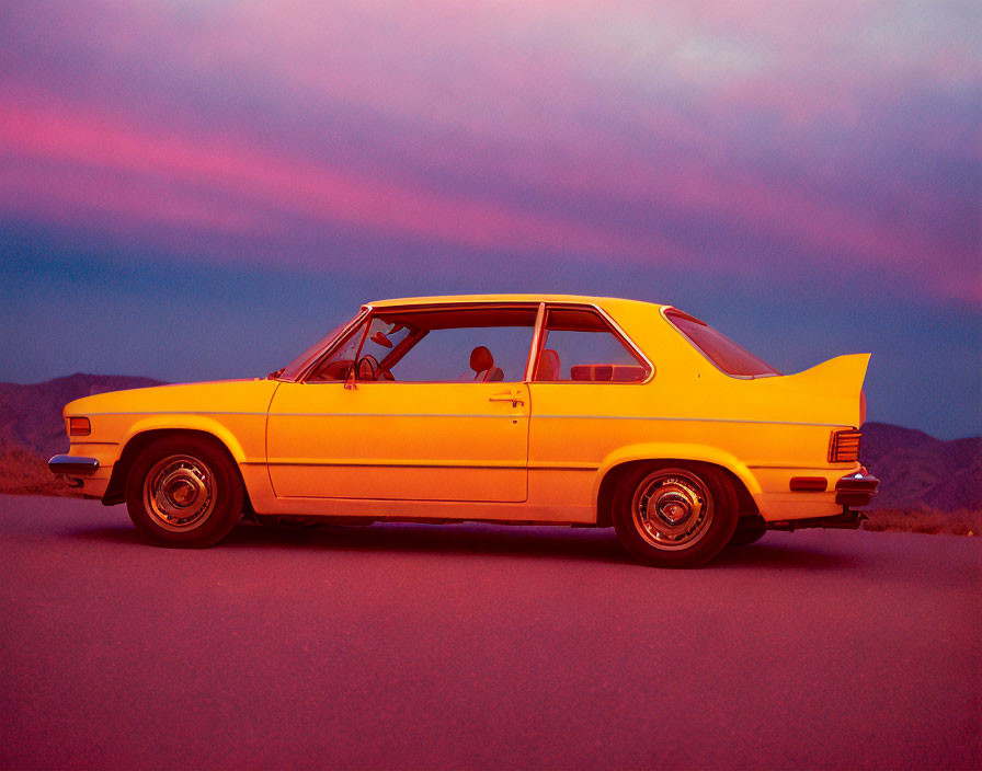 Vintage Yellow Car Parked on Road Under Purple Twilight Sky